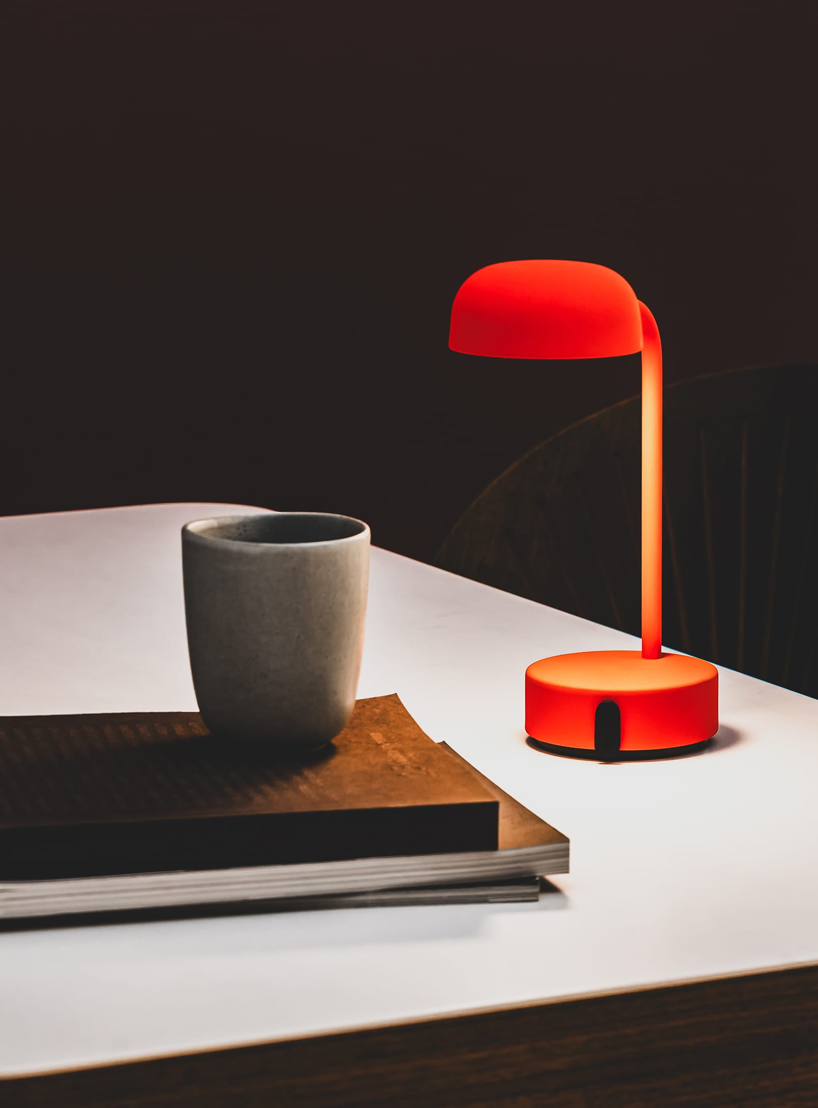 Illuminate your workspace with the Fokus Orange LED lamp by Kooduu, offering dimmable light for tasks or relaxation.