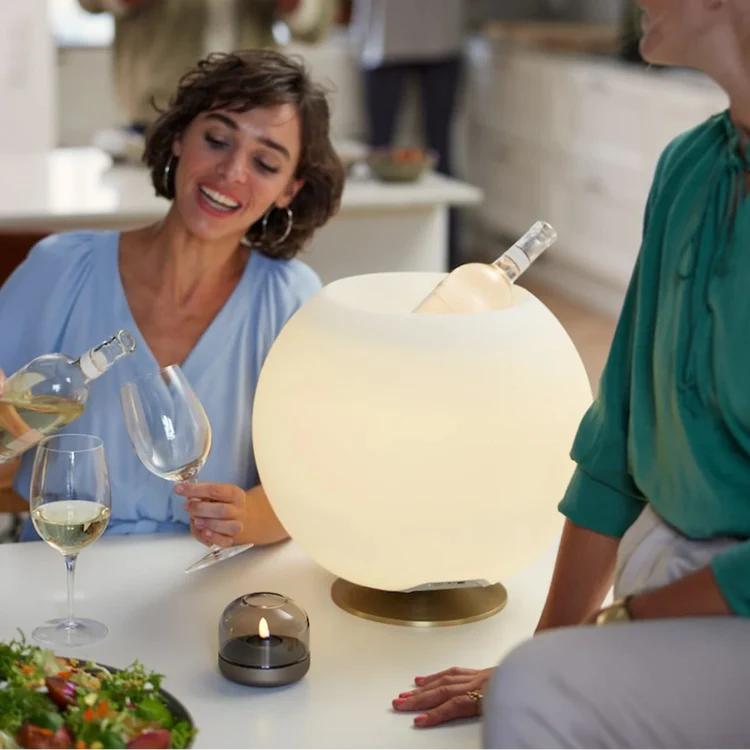 Add a touch of elegance and sophistication to your home decor with the Kooduu Sphere. This stylish drinks cooler and speaker lamp combination is designed to impress, with its sleek round shape, premium stand, and Bright Sound Technology™.
